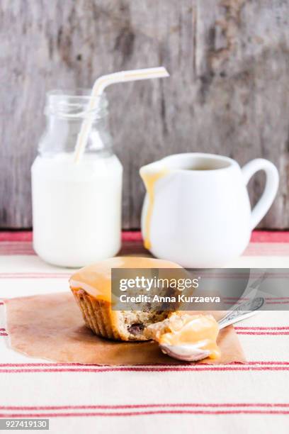 traditional british treat butterscotch pudding. mini cake with dates topped with caramel sauce with a bottle of fresh milk, selective focus. image with copy space. easter cake. - butterscotch stock pictures, royalty-free photos & images