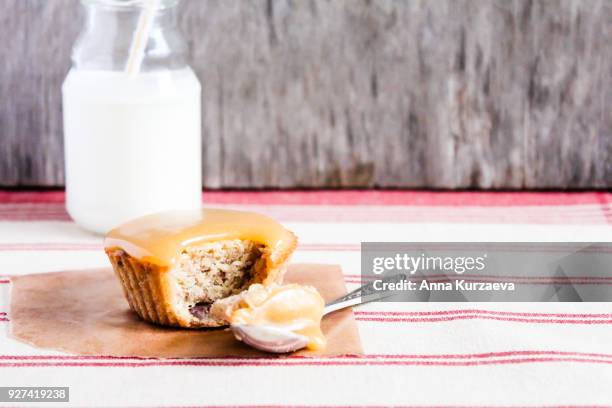 traditional british treat butterscotch pudding. mini cake with dates topped with caramel sauce with a bottle of fresh milk, selective focus. image with copy space. easter cake. - butterscotch stock pictures, royalty-free photos & images