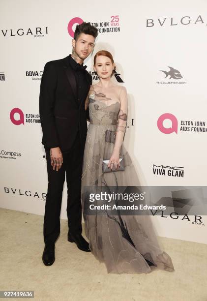 Actor Travis Mills and actress Madelaine Petsch arrive at the 26th Annual Elton John AIDS Foundation's Academy Awards Viewing Party on March 4, 2018...
