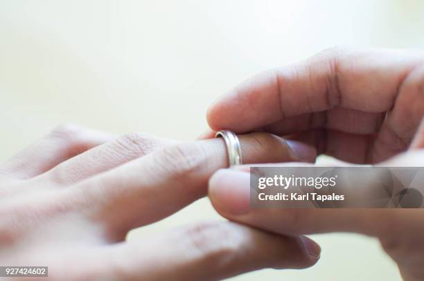 a man is holding his wedding ring - wedding problem stock pictures, royalty-free photos & images