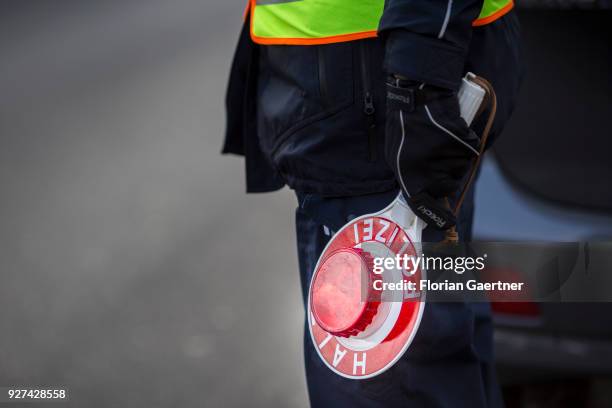 Police officer with police trowel during a traffic control in Berlin on February 27, 2018 in Berlin, Germany.