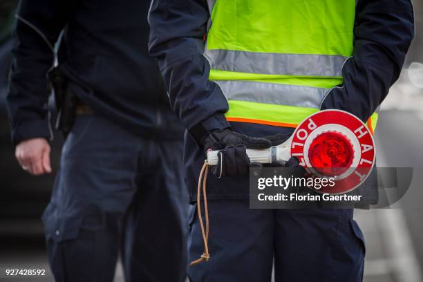 Police officer with police trowel during a traffic control in Berlin on February 27, 2018 in Berlin, Germany.