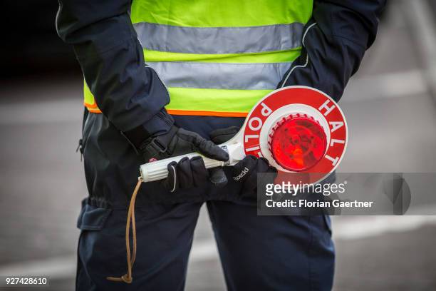 Police officer with police trowel during a traffic control in Berlin on February 27, 2018 in Berlin, Germany.