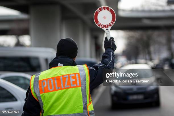 During a traffic control in Berlin a police officer stops a car with the help of a police trowel on February 27, 2018 in Berlin, Germany.