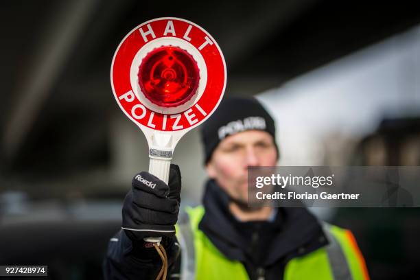 Police officer with police trowel during a traffic control in Berlin on February 27, 2018 in Berlin, Germany.