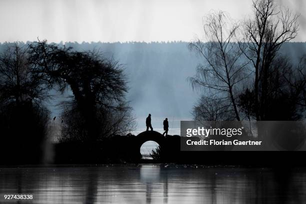 Two person walk near the lake Schwielowsee on March 03, 2018 in Petzow, Germany.