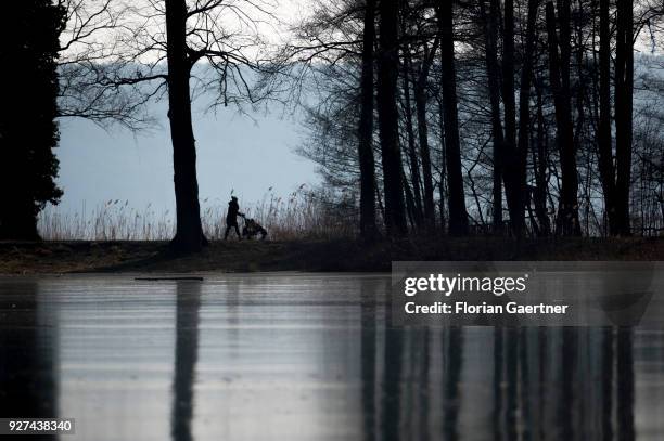 Woman with a buggy walks near the lake Schwielowsee on March 03, 2018 in Petzow, Germany.