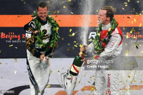 Race of Champions winner Sweden's Mattias Ekstrom celebrates with runner up Michael Schumacher of Germany after the Race of Champions Beijing 2009 at...