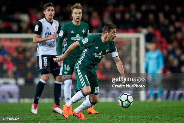 Marc Bartra of Real Betis Balompie with the ball next to Loren Moron of Real Betis Balompie and Gabriel Paulista of Valencia CF during the La Liga...