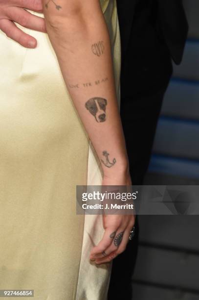 Miley Cyrus, tatoo detail, attends the 2018 Vanity Fair Oscar Party hosted by Radhika Jones at the Wallis Annenberg Center for the Performing Arts on...