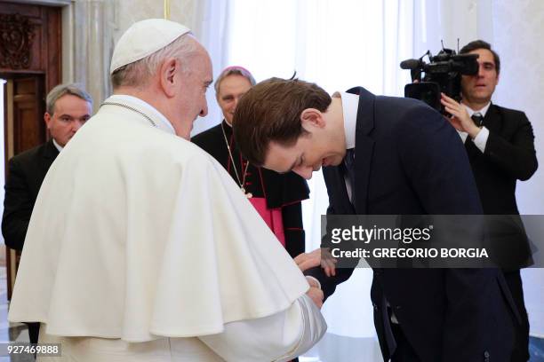 Pope Francis shakes hands with Austrian Chancellor Sebastian Kurz during a private audience at the Vatican on March 5, 2018. / AFP PHOTO / POOL /...