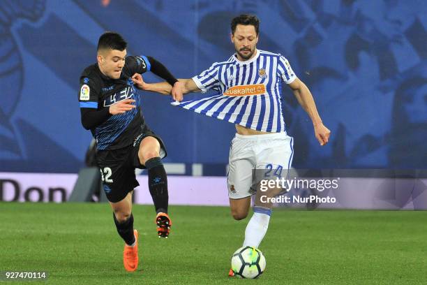 Martín Aguirregabiria of Alaves duels for the ball with De la Bella of Real Sociedad during the Spanish league football match between Real Sociedad...