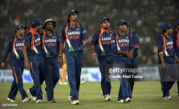 Indian cricketers Virender Sehwag, Ashish Nehra, Harbhajan Singh, Ishant Sharma and Sachin Tendulkar walk back with other team members after the end...
