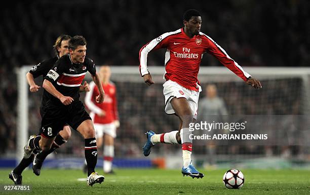 Arsenal's French midfielder Abou Diaby runs with the ball past AZ Alkmaar's Stijn Schaars during the Champions League Group H football match at The...