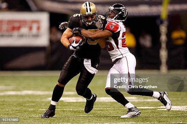 David Thomas of the New Orleans Saints runs for a first down against Erik Coleman of the Atlanta Falcons during the first quarter of the game at the...