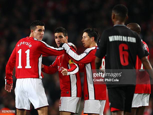 Cesc Fabregas of Arsenal celebrates scoring the first goal of the game while looking at David Mendes Da Silva of AZ Alkmaar during the UEFA Champions...