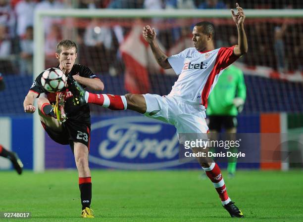 Aleksandr Hleb of VfB Stuttgart is tackled by Luis Fabiano of Sevilla during the UEFA Champions League Group G match between Sevilla and VfB...