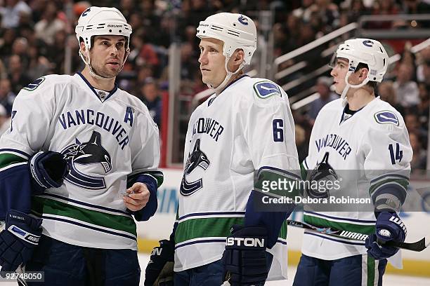 Ryan Kesler, Sami Salo and Alexandre Burrows of the Vancouver Canucks talk on the ice during the game against the Anaheim Ducks on October 30, 2009...