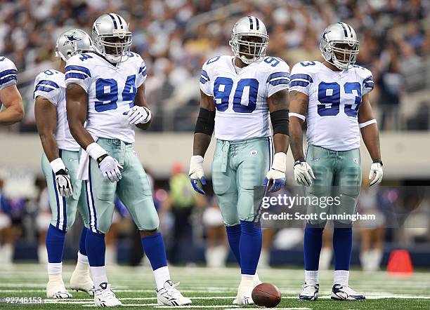 DeMarcus Ware, Jay Ratliff, and Anthony Spencer of the Dallas Cowboys gets set for a play against the Seattle Seahawks at Cowboys Stadium on November...