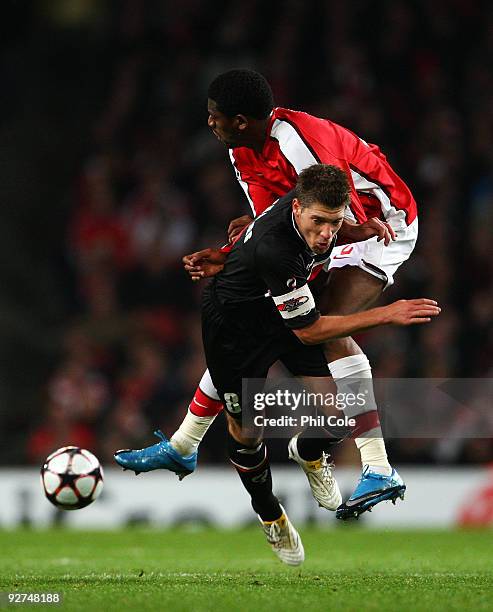 Abou Diaby of Arsenal colides with Stijn Schaars of AZ Alkmaar during the UEFA Champions League Group H match between Arsenal and AZ Alkmaar at the...