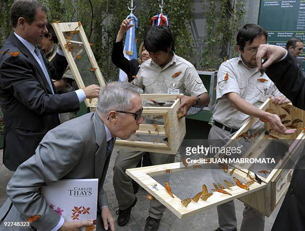 French ambassador to Argentina, Frederic Baleine du Laurens blows at butterflies during the opening ceremony of the "Carlos Thays, un jardinero...