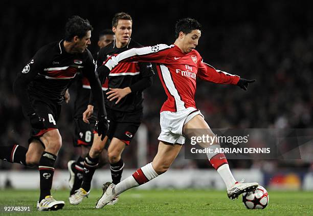 Arsenal's French midfielder Samir Nasri runs with the ball past AZ Alkmaar's Mexican player Hector Moreno during the Champions League Group H...