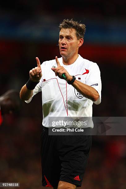 Referee Alain Hamer speaks to a player during the UEFA Champions League Group H match between Arsenal and AZ Alkmaar at the Emirates Stadium on...