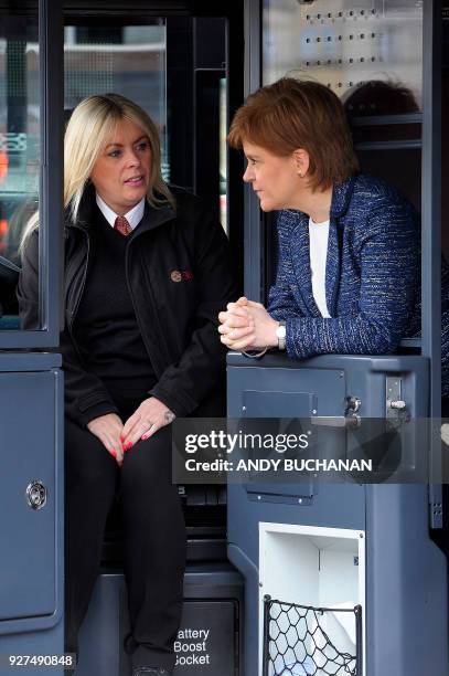 Scotland's First Minister Nicola Sturgeon meets Charmaine Laurie, a bus driver at the Lothian Bus central garage in Edinburgh on March 5, 2018....
