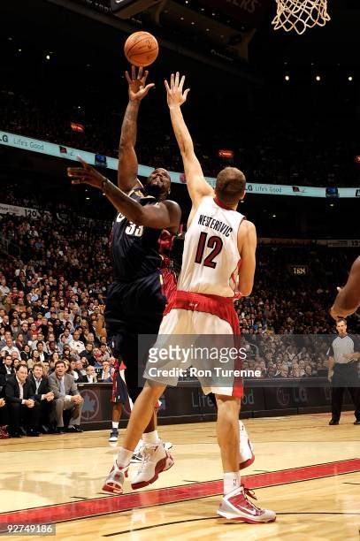 Shaquille O'Neal of the Cleveland Cavaliers puts up a shot against Rasho Nesterovic of the Toronto Raptors during the game on October 28, 2009 at Air...