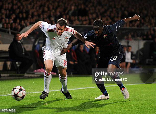 Jamie Carragher of Liverpool battles with Aly Cissokho of Lyon during the UEFA Champions League Group E match between Liverpool and Lyon at the Stade...