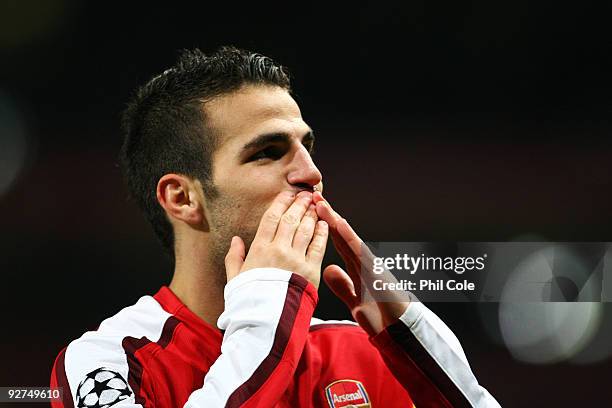 Cesc Fabregas of Arsenal celebrates scoring his second and the teams the third goal of the game during the UEFA Champions League Group H match...