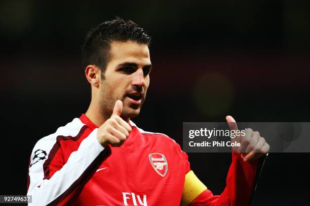 Cesc Fabregas of Arsenal celebrates scoring his second and the teams the third goal of the game during the UEFA Champions League Group H match...