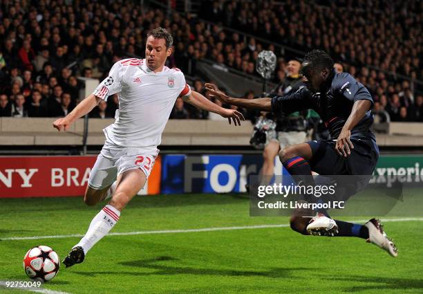 Jamie Carragher of Liverpool battles with Aly Cissokho of Lyon during the UEFA Champions League Group E match between Liverpool and Lyon at the Stade...