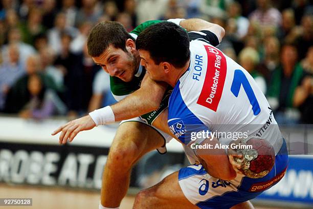 Michael Haass of Goeppingen is challenged by Matthias Flohr of Hamburg during the Toyota Handball Bundesliga match between FA Goeppingen and HSV...