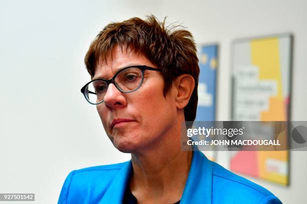 German secretary general of the Christian Democratic Union Annegret Kramp-Karrenbauer speaks to journalists as she walks out after addressing a press...