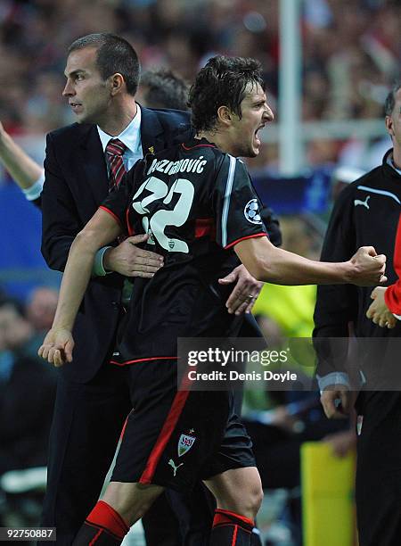 Zdravko Kuzmanovic of VfB Stuttgart celebrates with head coach Markus Babbel after scoring his team's first goal during the UEFA Champions League...