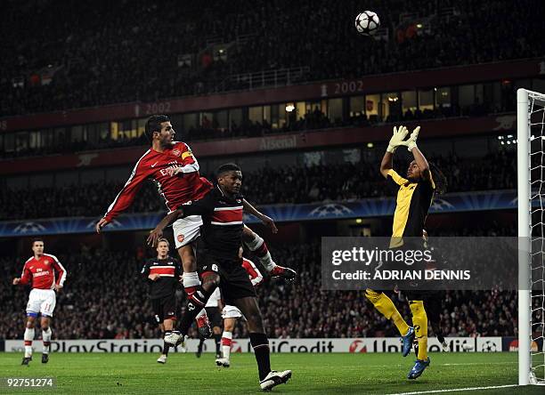 Arsenal's Spanish midfielder Cesc Fabregas watches as his header goes over AZ Alkmaar's Argentine goalkeeper Sergio Romero during the Champions...