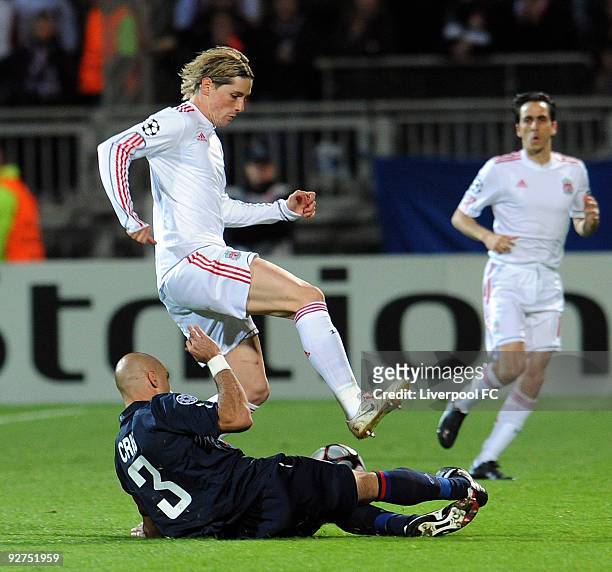 Fernando Torres of Liverpool competes with Cris of Lyon during the UEFA Champions League Group E match between Liverpool and Lyon at the Stade de...