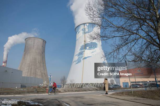 Man cycles next to the PGE Power Station in Krakow. The city of Krakow is the second largest city in Poland, it has a population of over 760,000 in...