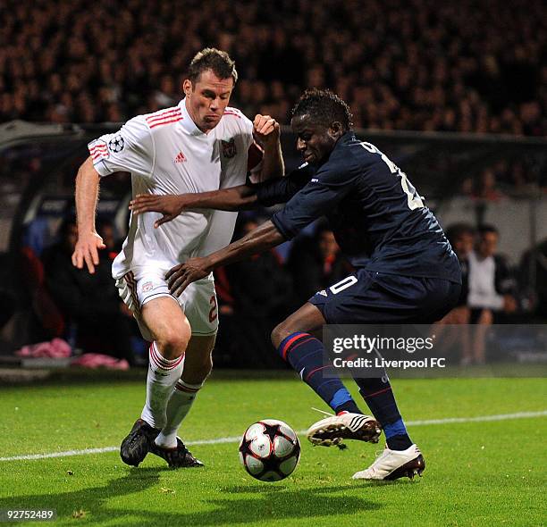 Jamie Carragher of Liverpool battles with Aly Cissokho of Lyon during the UEFA Champions League Group E match between Liverpool and Lyon at the Stade...