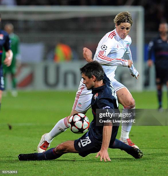 Fernando Torres of Liverpool competes with Jeremy Toulalan of Lyon during the UEFA Champions League Group E match between Liverpool and Lyon at the...