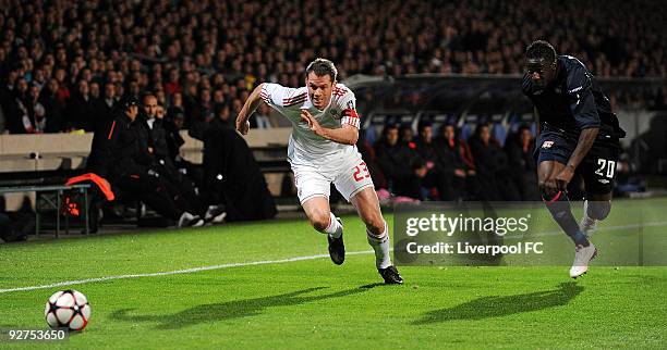 Jamie Carragher of Liverpool battles with Aly Cissokho of Lyon during the UEFA Champions League Group E match between Liverpool and Lyon at the Stade...