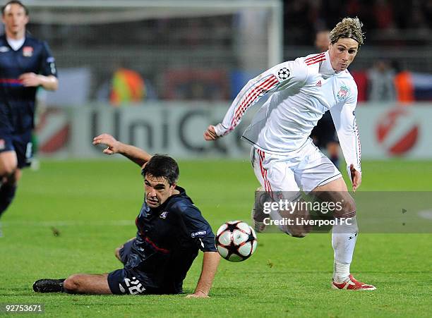 Fernando Torres of Liverpool competes with Jeremy Toulalan of Lyon during the UEFA Champions League Group E match between Liverpool and Lyon at the...