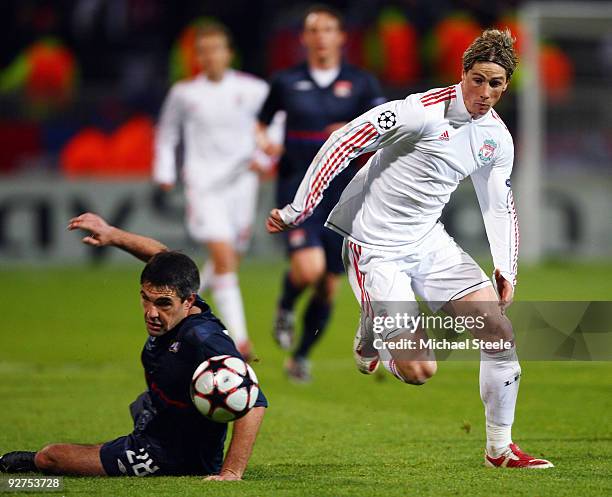 Fernando Torres of Liverpool avoids the challenge of Jeremy Toulalan during the Lyon v Liverpool UEFA Champions League Group E match at the Stade de...