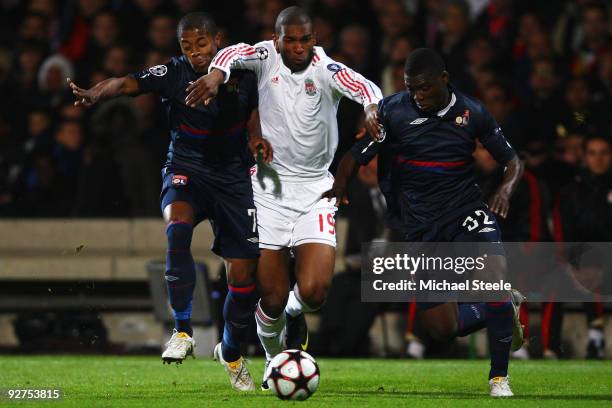 Ryan Babel of Liverpool battles his way through Michel Bastos and Aly Cissokho during the Lyon v Liverpool UEFA Champions League Group E match at the...