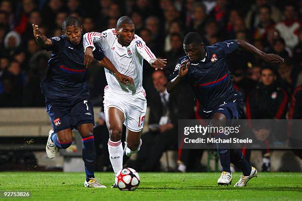 Ryan Babel of Liverpool battles his way through Michel Bastos and Aly Cissokho during the Lyon v Liverpool UEFA Champions League Group E match at the...