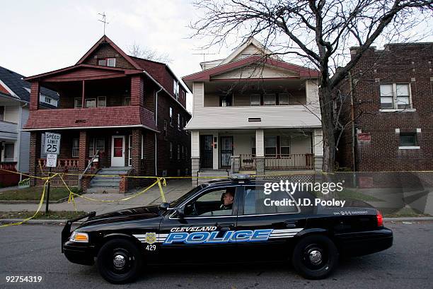 Police car sits outside the home of Anthony Sowell November 4 in Cleveland, Ohio. Sowell has been in jail since last week, charged with murder, rape...