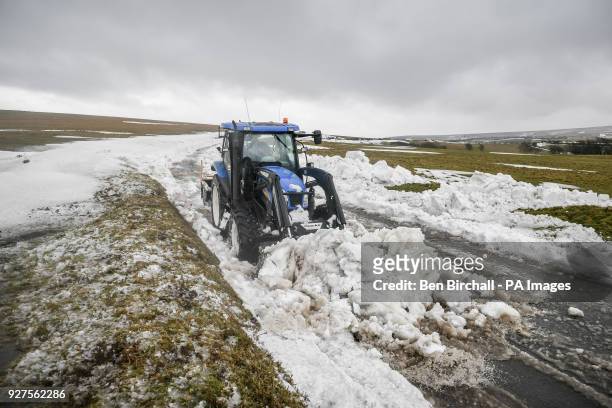 Farm machinery is used to clear snow from a section of the A39 at Porlock Hill, near Lynton, Exmoor, after heavy snow drifts affected the area and...