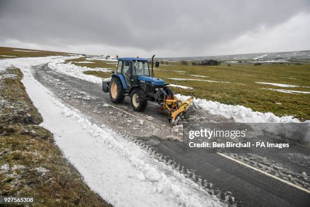 Farm machinery is used to clear snow from a section of the A39 at Porlock Hill, near Lynton, Exmoor, after heavy snow drifts affected the area and...