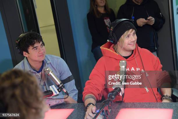 Bassist Calum Hood and guitarist Michael Clifford of 5 Seconds of Summer visit "The Elvis Duran Z100 Morning Show" at Z100 Studio on March 5, 2018 in...